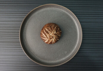 steamed fresh mushroom cheesy bun baozi in mushroom shape on dark grey wood background dim sum...