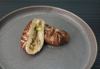 steamed fresh mushroom cheesy bun baozi in mushroom shape on dark grey wood background dim sum...