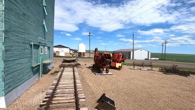 Old train tracks are on display in a small town near Oyen Alberta Canada on a sunny day.