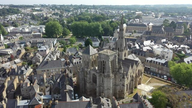 Aerial view of historic centre of Guingamp overlooking ancient Basilica of Notre Dame de Bon Secours, Brittany, France. High quality 4k footage