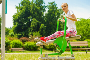 Girl doing legs exercise at outdoor gym area
