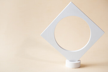 White podium on beige background. Template, mock up for presentation products. Pastel colors styled composition with geometrical forms. Minimal concept. Product podium.