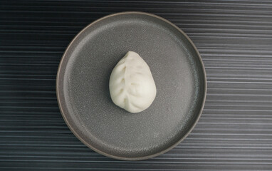 steamed fresh vegetables bun white baozi in leaf shape on dark grey wood background dim sum halal...