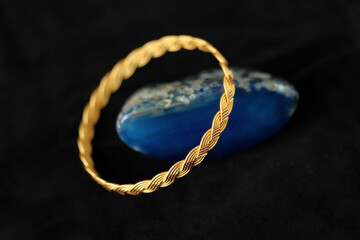 Gold bracelet on blue agate stone