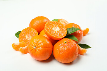 Mandarin pile with leaves on white background