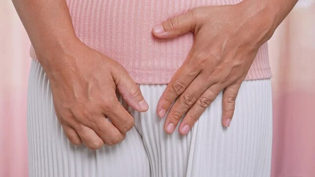 Female hands scratching crotch with leucorrhoea, vaginitis, problems of bacterial vaginosis, vaginal itching and unpleasant smell. Gynecological and health care concept.