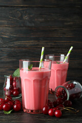 Cherry smoothie and ingredients on rustic wooden table
