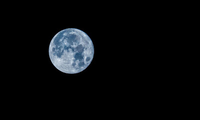 Full Blue Moon in a Black Night Sky
