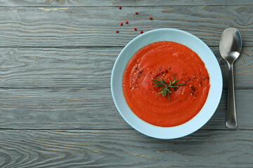 Concept of tasty eating with Gazpacho soup on gray wooden background