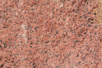 Torn edge of the red granite block, texture, background