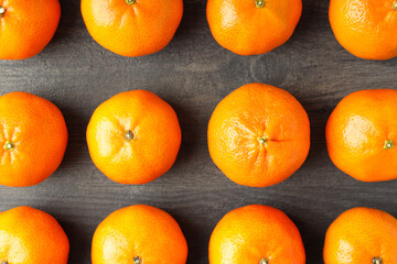 Flat lay with tasty mandarins on textured wooden table