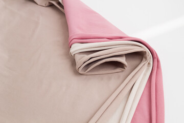 Rolls of bright colored fabric on a white background.