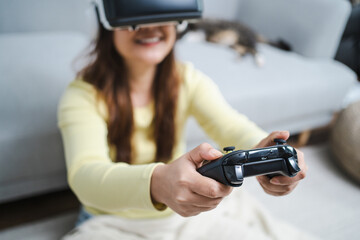 Young Asian woman wearing virtual reality touching air during the VR experience  Future technology concept.