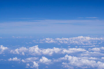 Aerial view of clouds and sky as seen through the window of an aircraft