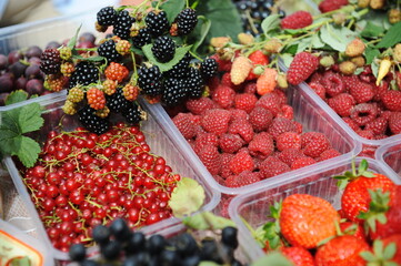 Containers with different types of seasonal berries