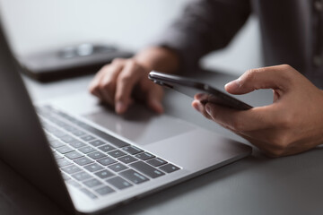 Businessman working with devices. Student using laptop computer and mobile smart phone, business...