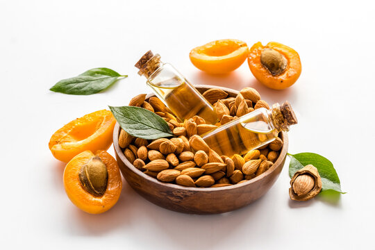 Apricot kernel oil in glass bottles with ripe apricot fruits