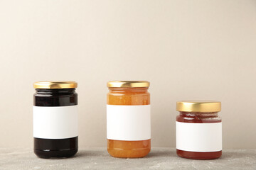 Assortment of jam jars mock-up. Jars with blank label on grey