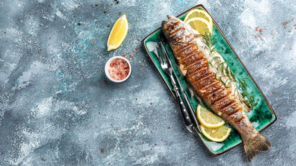 Grilled trout barbeque with lemon, Healthy eating concept. banner, menu, recipe place for text, top view