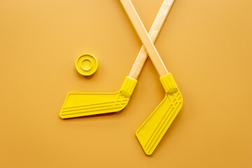 Competitive sports equipment with hockey sticks and puck. Top view