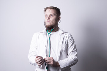 Male doctor in laboratory coat on gray background