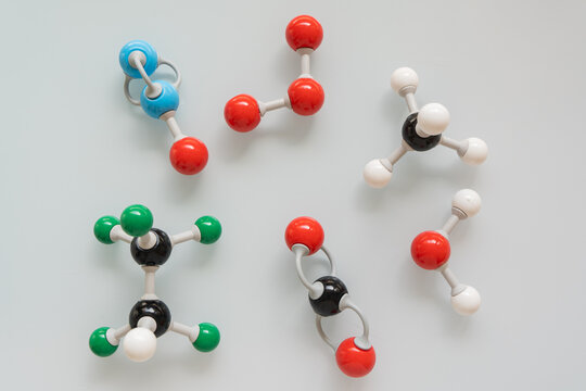 Picture of different greenhouse gases made by molecular model on white background. Chemical formula of nitrogen monoxide, carbon dioxide, methane, water, ozone and HFC - 125.