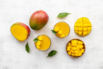 Top view of mango slices and cubes with fresh mango smoothie