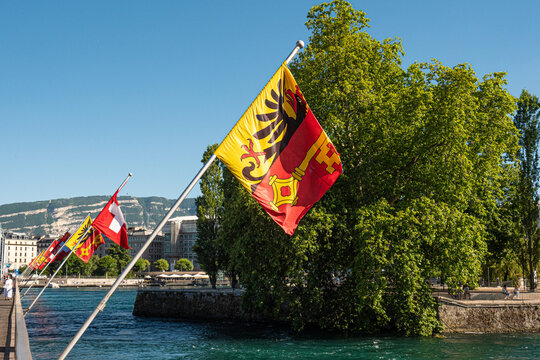 Flags of Switzerland and the City of Geneva on a bridge in Geneva - CITY OF GENEVA, SWITZERLAND - JULY 8, 2020
