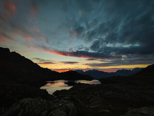 sunrise, sunset, high mountain lake adamello brenta, italy, dolomites