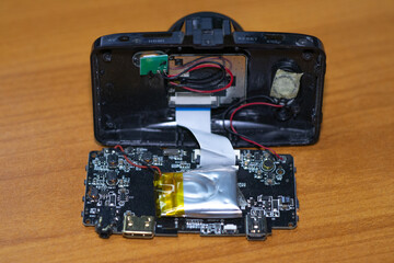 Parts of Car camcorder or Dashboard camera (Car Camera) are separated for repair on the wood board