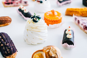 Assortment of confectionery, different types of cakes and desserts on the table.