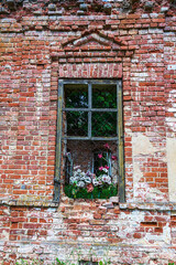 Fototapeta na wymiar an old window in the brick wall of an abandoned church