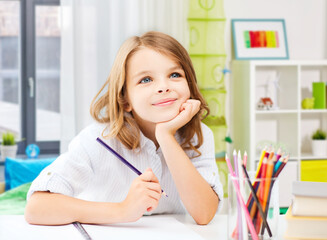 education and school concept - happy student girl drawing with pencils over home room background