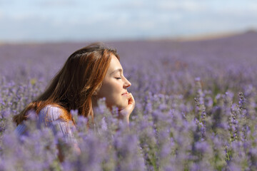 Woman resting and relaxing in the middle of lavender field