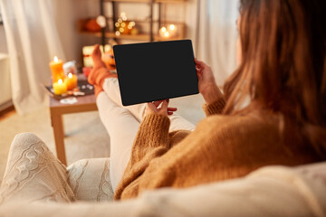 halloween, holidays and leisure concept - young woman with tablet pc computer at home