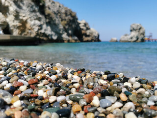 View of the pebble beach and the sea with rocks. the Aegean sea. Turkey, Kusadasi.