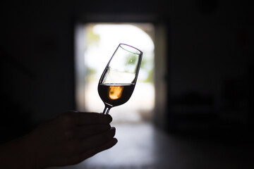 a glass of sherry wine in hand