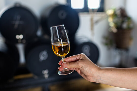 a glass of sherry wine in hand