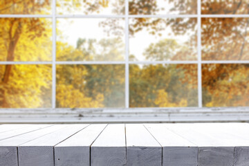 Desk of free space and autumn window background 