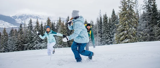 Papier Peint photo autocollant Tatras Family with small daughter having fun outdoors in winter nature, Tatra mountains Slovakia.