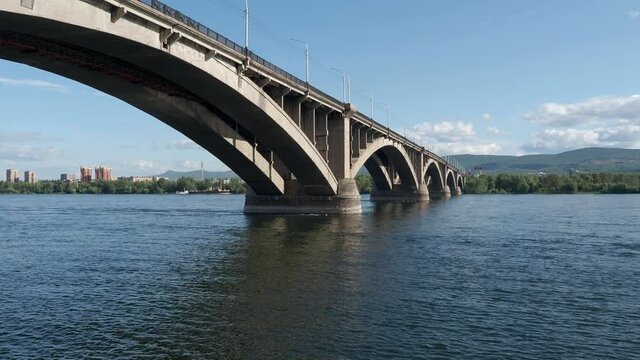 The Communal bridge of Krasnoyarsk during sunny summer day. Yenisei river and Communal bridge. Video 4k resolution