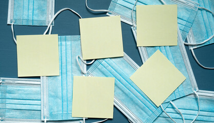 protective medical masks, blue color, reminders, yellow cards, photo from above