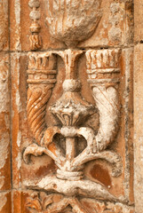 High and low relief on the wall door of the ancient gothic church, carved details - Selective focus, Vertical
