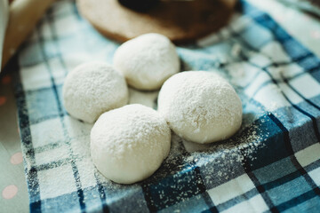 Rady made doughs with flour powder on top. Raw round dough on blue and white checkered cloth.Rolling pin.Baking processTraditional kneading.Healthy pastry from wheat.Buns and pizza dough. - obrazy, fototapety, plakaty