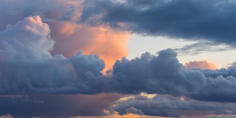 Beautiful colored dramatic cumulus clouds on sky at sunset