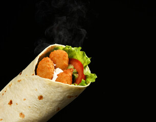 Classic tortilla wrap roll with nuggets and vegetables, tomato, lettuce on black background - obrazy, fototapety, plakaty