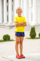 Blonde little boy in a summer park