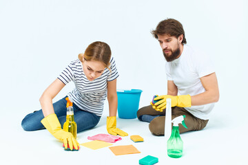 Man and woman near the sofa room cleaning provision of services