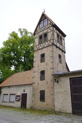 Fototapeta na wymiar The hose tower of the former Mirow fire station in Mirow (Mecklenburg-Western Pomerania), Am Wallgraben on the castle island next to the tool shed, dates from 1926.