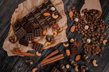 Background with chocolate. Dark organic chocolate with nuts, anise and cinnamon and coffee beans on...